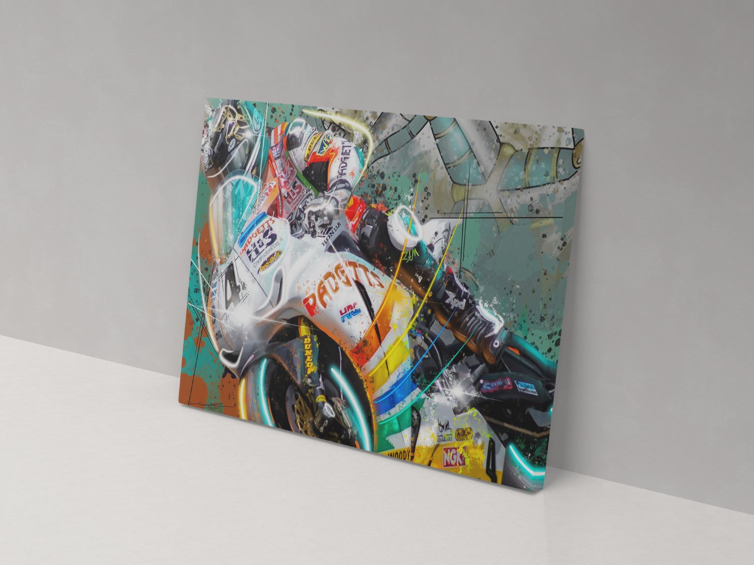 A canvas print featuring a colorful illustration of a motorcycle racer in action, mounted on a wall.