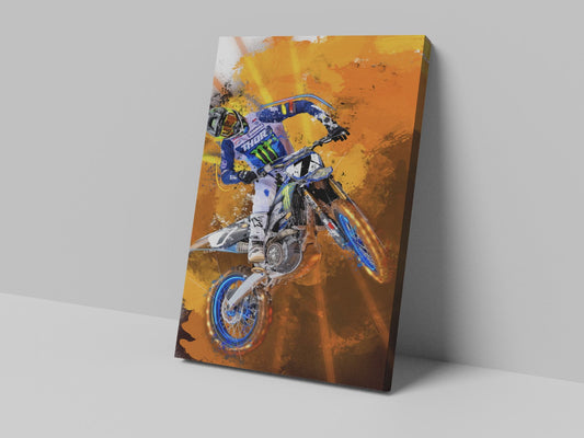 A canvas print featuring an action shot of a motocross rider in mid-air, with a vibrant orange and yellow background.
