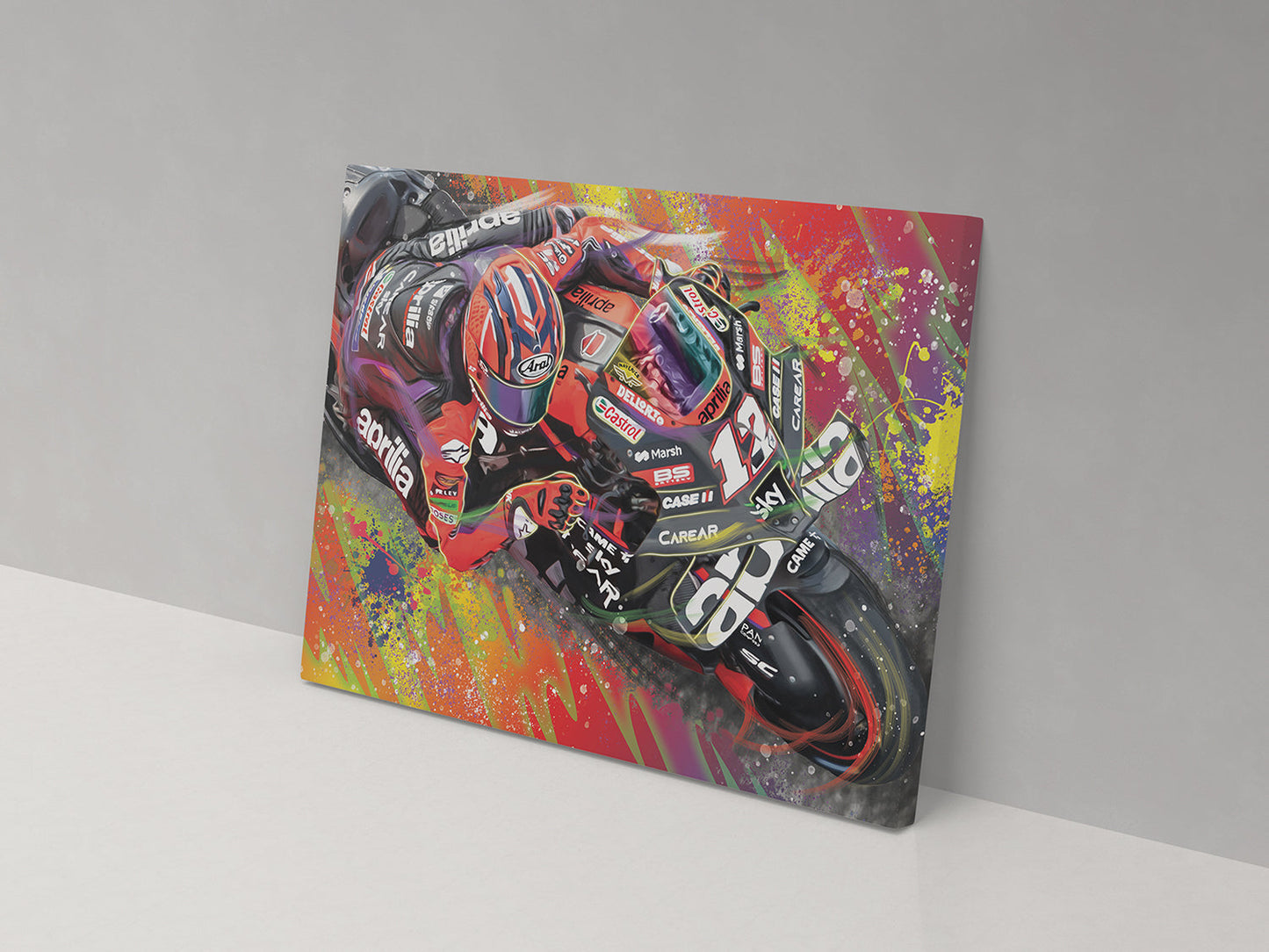 A canvas print featuring a colorful artistic depiction of a motorcycle racer on a motorcycle with splashes of multicolored paint around.